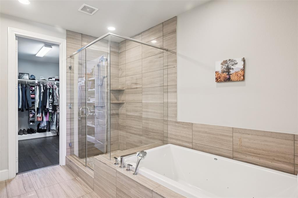 2815 Lynlock Court Dallas, TX 75219 - Photo 21 of 39 a bathroom with a bathtub and a shower