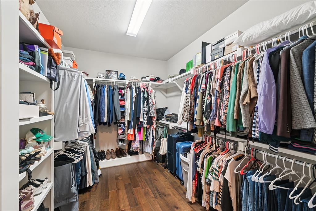 2815 Lynlock Court Dallas, TX 75219 - Photo 23 of 39 a view of walk in closet with clothes