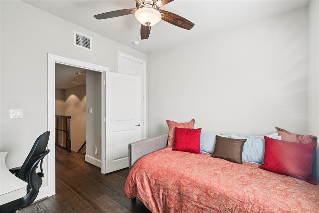 2815 Lynlock Court Dallas, TX 75219 - Photo 25 of 39 a bedroom with a bed and a chandelier