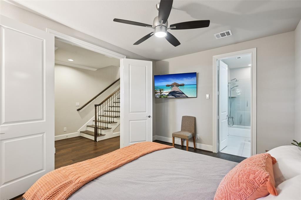 2815 Lynlock Court Dallas, TX 75219 - Photo 30 of 39 a bedroom with a bed and a chair