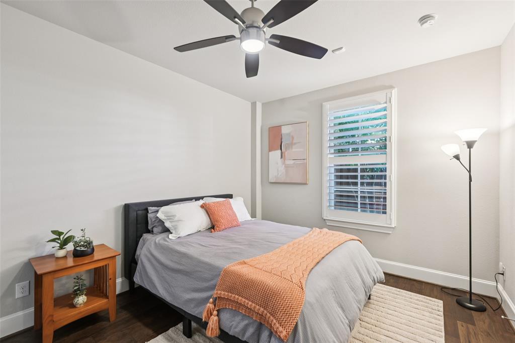 2815 Lynlock Court Dallas, TX 75219 - Photo 31 of 39 a bedroom with a bed and wooden floor