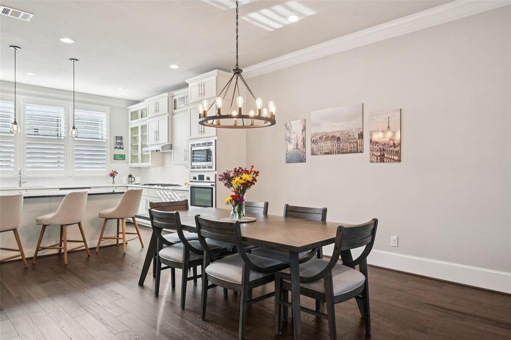 2815 Lynlock Court Dallas, TX 75219 - Photo 8 of 39 a view of a dining room with furniture wooden floor and chandelier