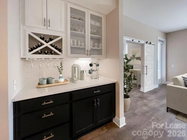 a living room with furniture and a dining table with kitchen view