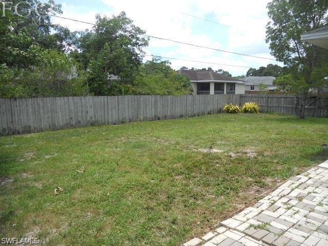 8402 Butternut Road Fort Myers, FL 33967 - Photo 13 of 13 a view of a backyard with potted plants and wooden fence