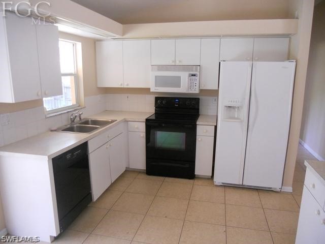 8402 Butternut Road Fort Myers, FL 33967 - Photo 6 of 13 a kitchen with a sink a stove and refrigerator