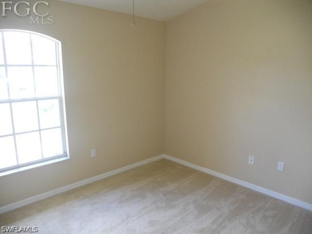 8402 Butternut Road Fort Myers, FL 33967 - Photo 9 of 13 an empty room with a window