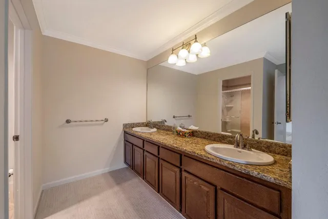 a bathroom with a granite countertop sink a light fixture and a mirror