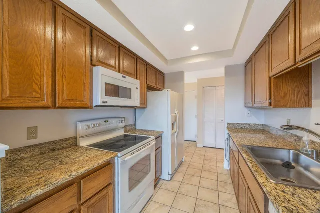 a kitchen that has a sink and a stove in it