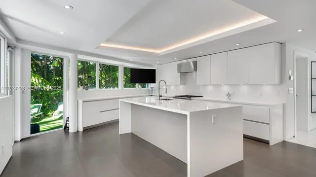 a kitchen with counter top space sink and stove
