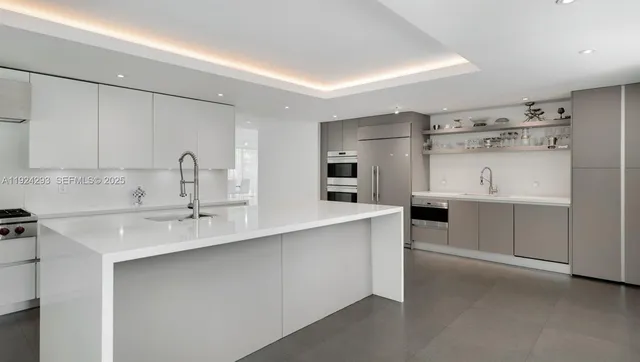 a kitchen with cabinets a sink and white stainless steel appliances