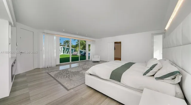 a spacious bedroom with a bed and a window