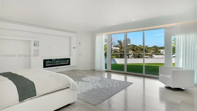 a bedroom with a bed and a view of living room