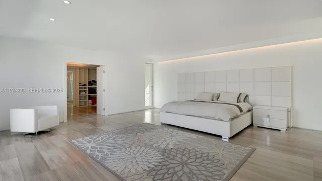 a spacious bedroom with a bed and a couch