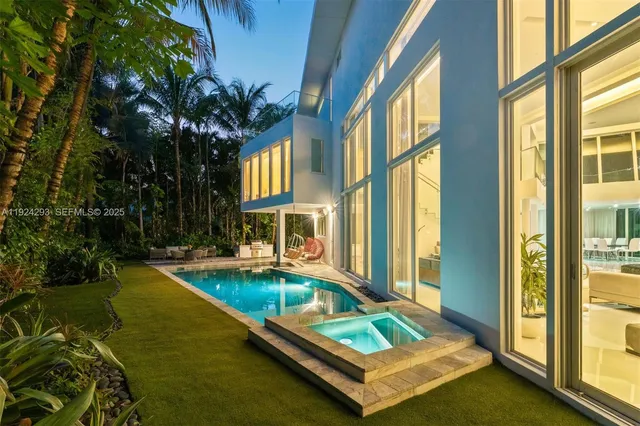 a view of a house with swimming pool and sitting area
