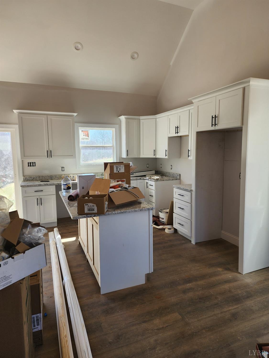 3025 Hawkins Ridge Road Goode, VA 24556 - Photo 3 of 8 a kitchen with stainless steel appliances kitchen island granite countertop a stove refrigerator sink and cabinets