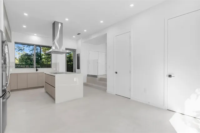 a kitchen with a sink and large window