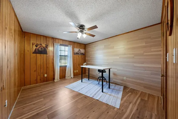 a roof deck with wooden floor and yard