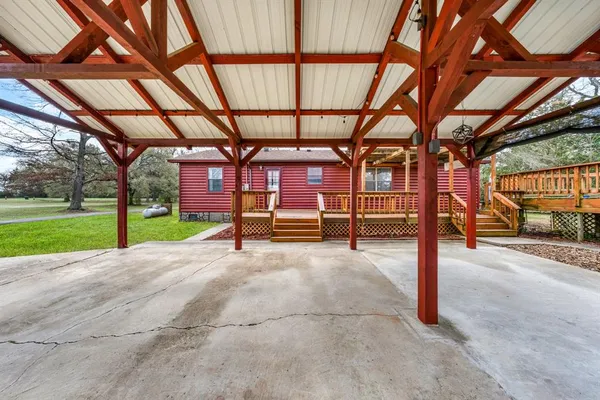 an aerial view of a house with a yard and a large tree