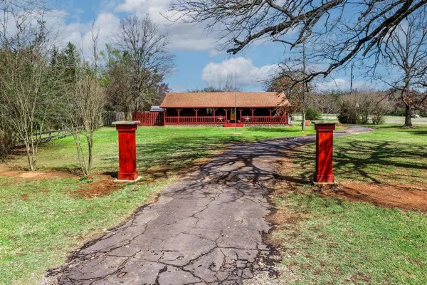 a view of a house with a yard and sitting area