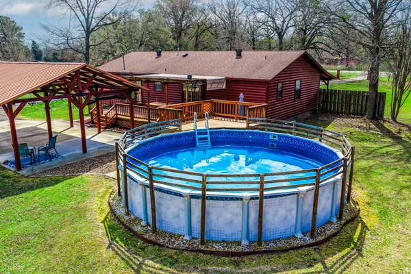 a view of a chairs and table in the backyard
