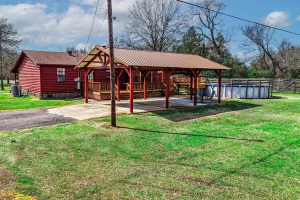 a view of a house with a yard and sitting area