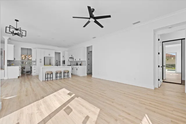 a kitchen with stainless steel appliances a refrigerator stove and white cabinets