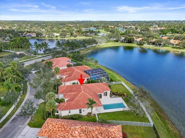 an aerial view of residential houses with outdoor space and river