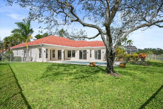 an aerial view of residential houses with outdoor space and lake view