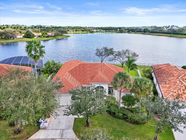 an aerial view of a residential houses with outdoor space and seating