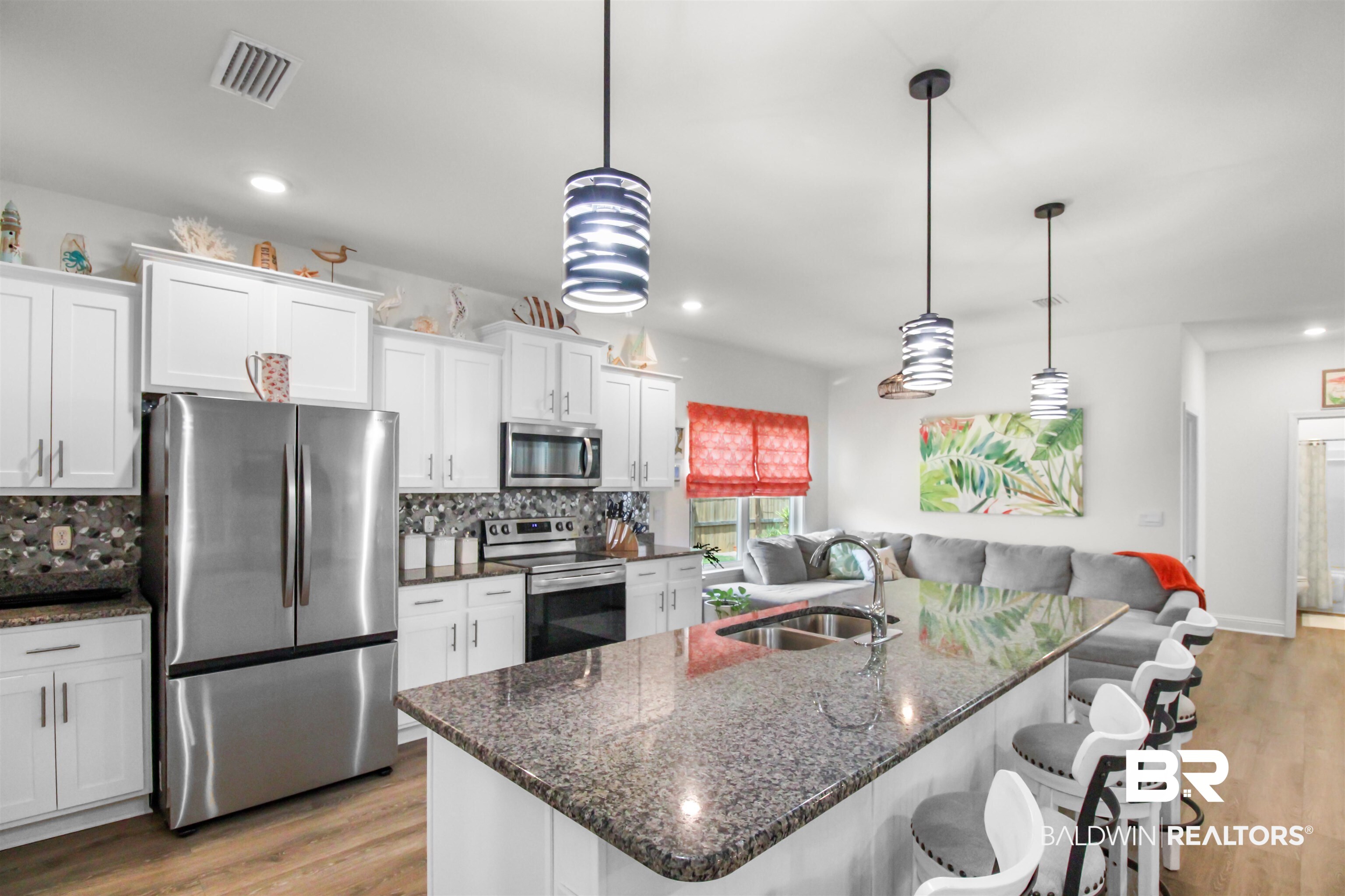 1885 Carly Street Foley, AL 36535 - Photo 6 of 40 Kitchen island featuring a granite countertop, undermount sink, and pendant lighting