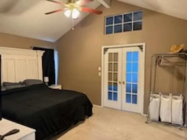 a bedroom with a bed and a large window