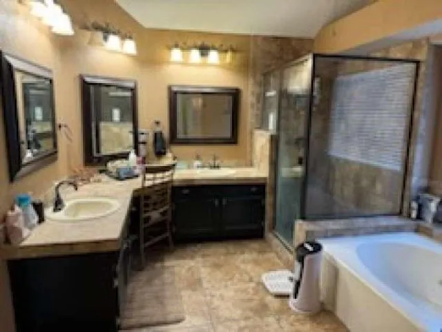 a bathroom with a tub sink and mirror