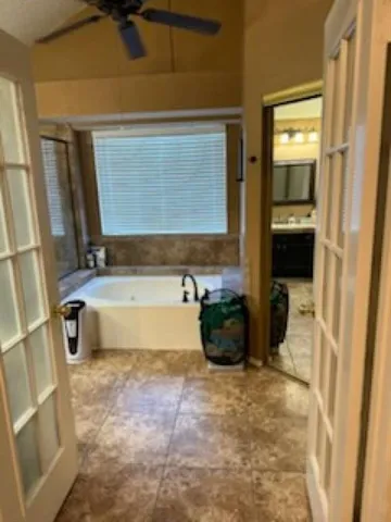 a bathroom with a tub sink and mirror
