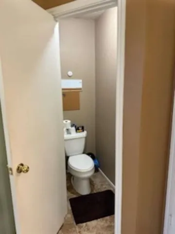 a white toilet sitting next to a bathroom sink