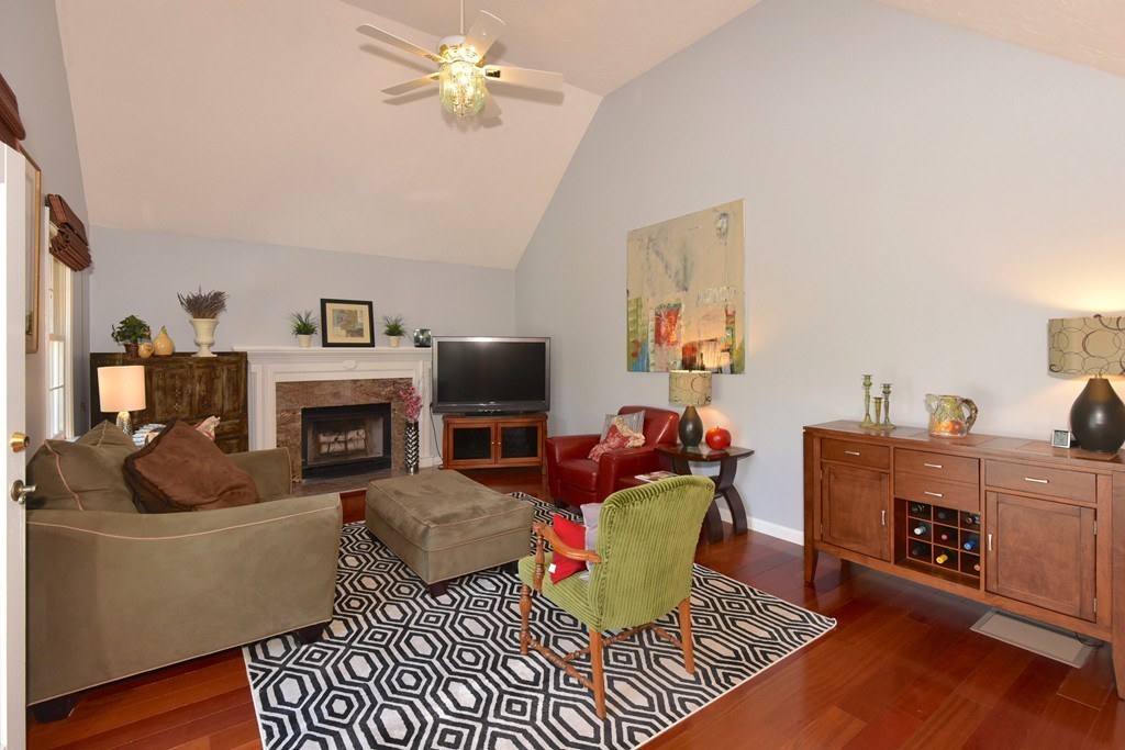 283 Potter Road Framingham, MA 01701 - Photo 14 of 29 a living room with furniture a fireplace and a flat screen tv