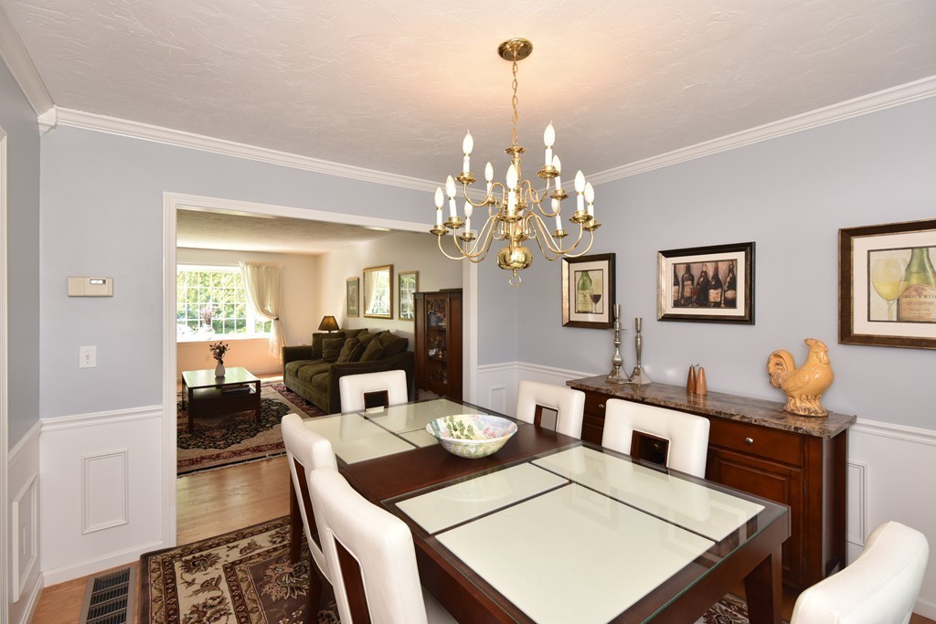 283 Potter Road Framingham, MA 01701 - Photo 19 of 29 a view of a dining room with furniture a chandelier and wooden floor