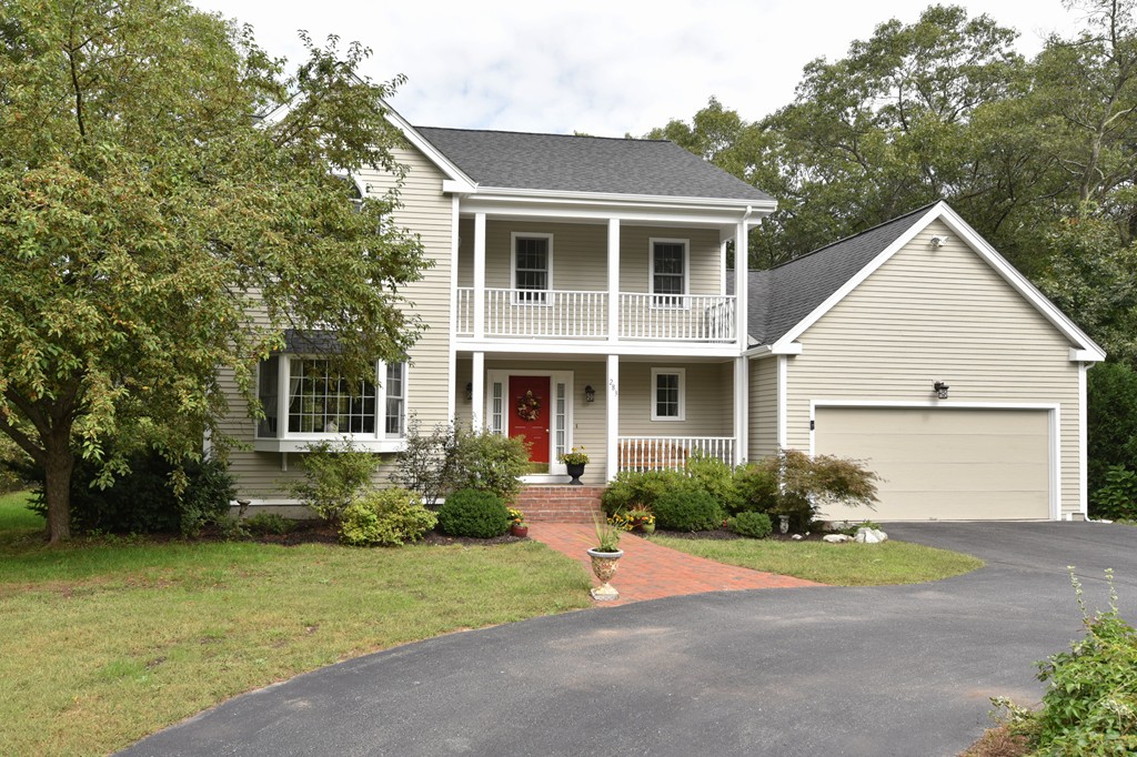 283 Potter Road Framingham, MA 01701 - Photo 2 of 29 a front view of a house with a yard and garage