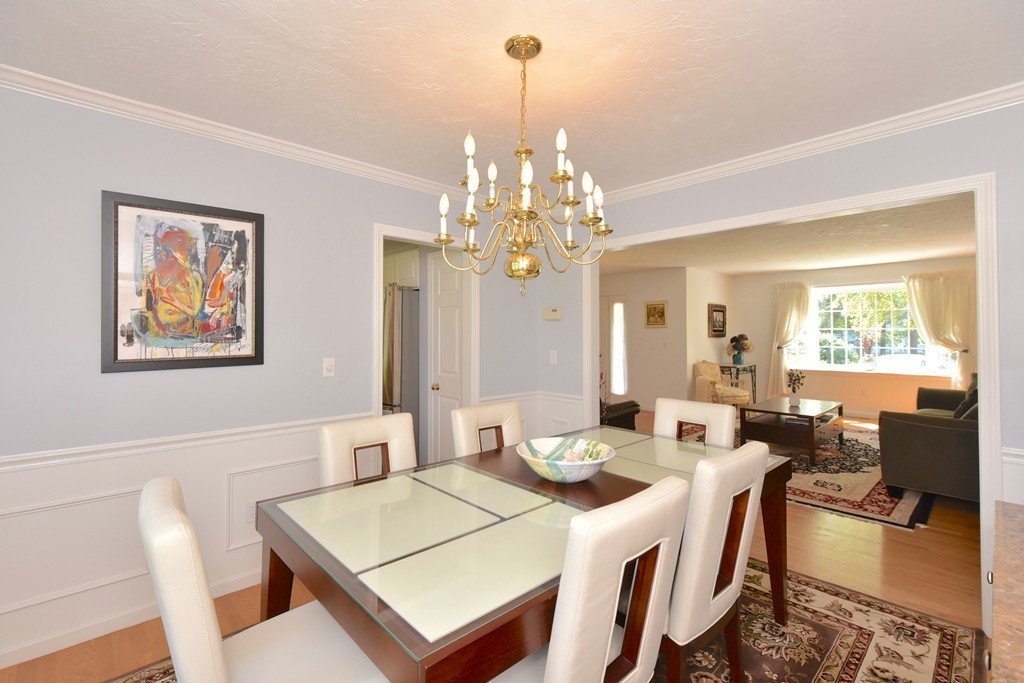 283 Potter Road Framingham, MA 01701 - Photo 21 of 29 a view of a dining room with furniture a chandelier and wooden floor