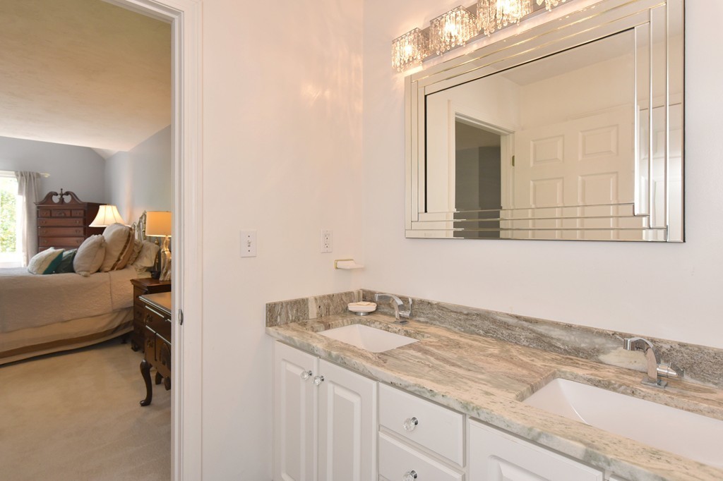 283 Potter Road Framingham, MA 01701 - Photo 25 of 29 a en suite bathroom with a granite countertop sink and a mirror