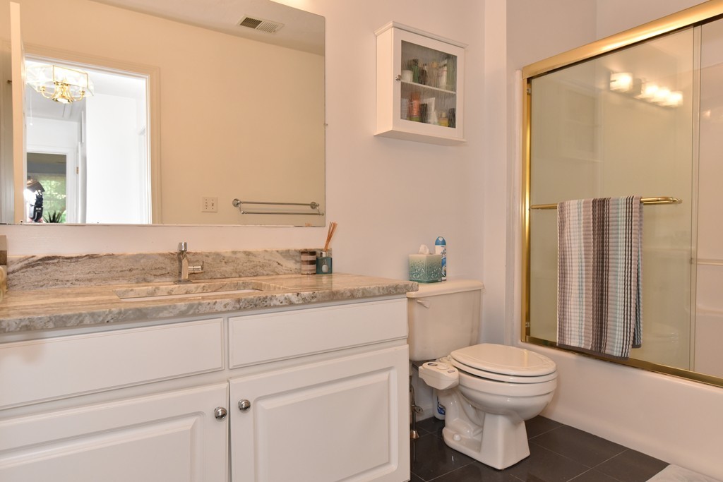283 Potter Road Framingham, MA 01701 - Photo 29 of 29 a bathroom with a granite countertop toilet sink and a mirror