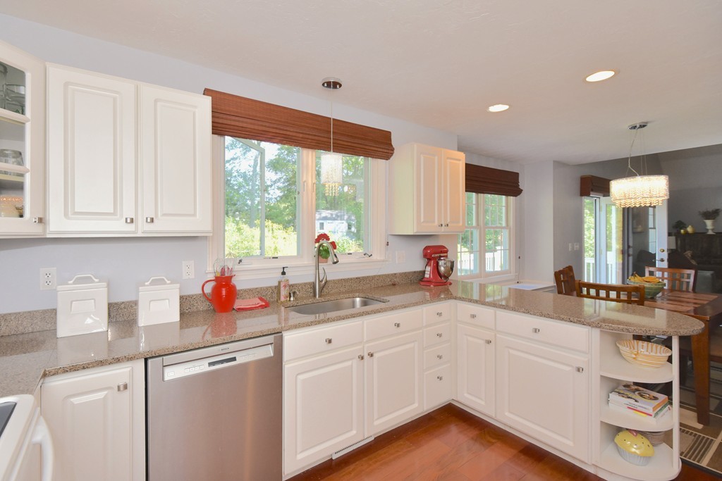 283 Potter Road Framingham, MA 01701 - Photo 9 of 29 a kitchen with white cabinets and sink