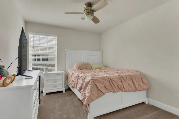 a bedroom with a bed and flat screen tv