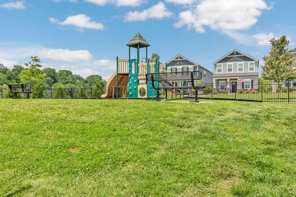 a view of an house with a big yard and garden