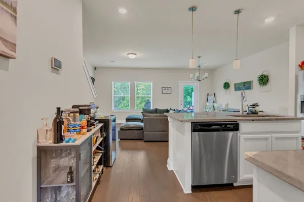 a living room with kitchen island furniture and a wooden floor
