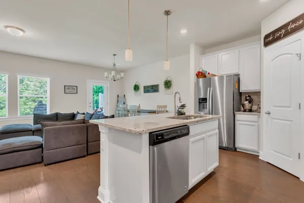 a kitchen with stainless steel appliances granite countertop a refrigerator a oven a stove and a refrigerator