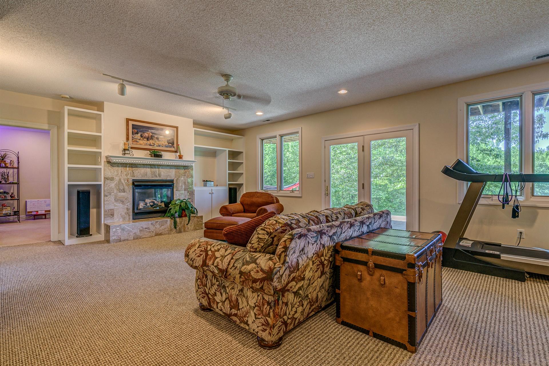 1899 Retreat Road Boones Mill, VA 24065 - Photo 38 of 76 a living room with furniture a fireplace and a flat screen tv