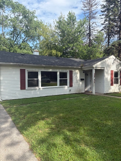 a front view of house with yard and green space