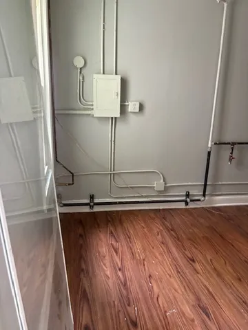 a room with wooden floor and shoes