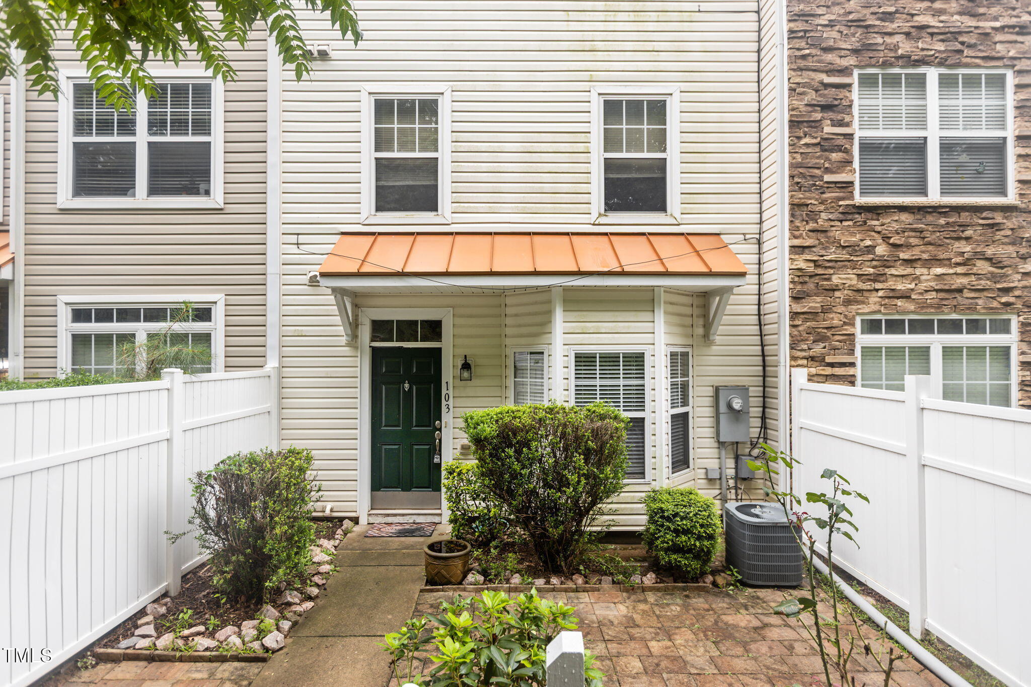 a view of a house with potted plants