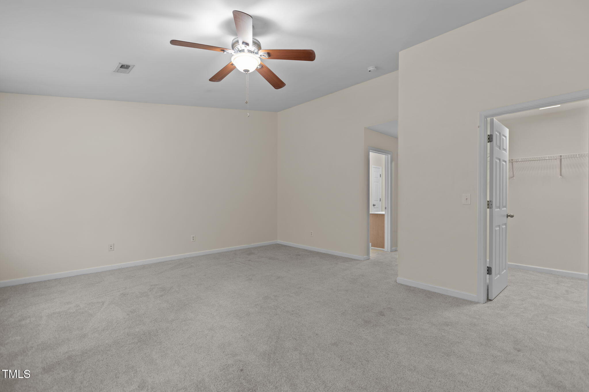 11720 Mezzanine Drive, Unit 103 Raleigh, NC 27614 - Photo 12 of 18 an empty room with chandelier fan